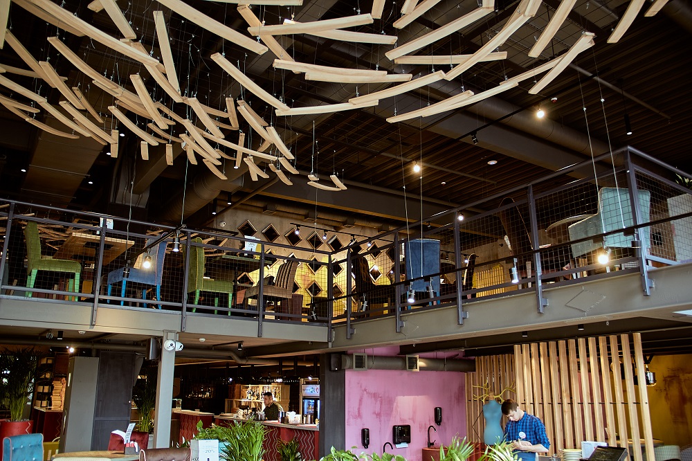 Upper floor of a restaurant with modern decor and seating